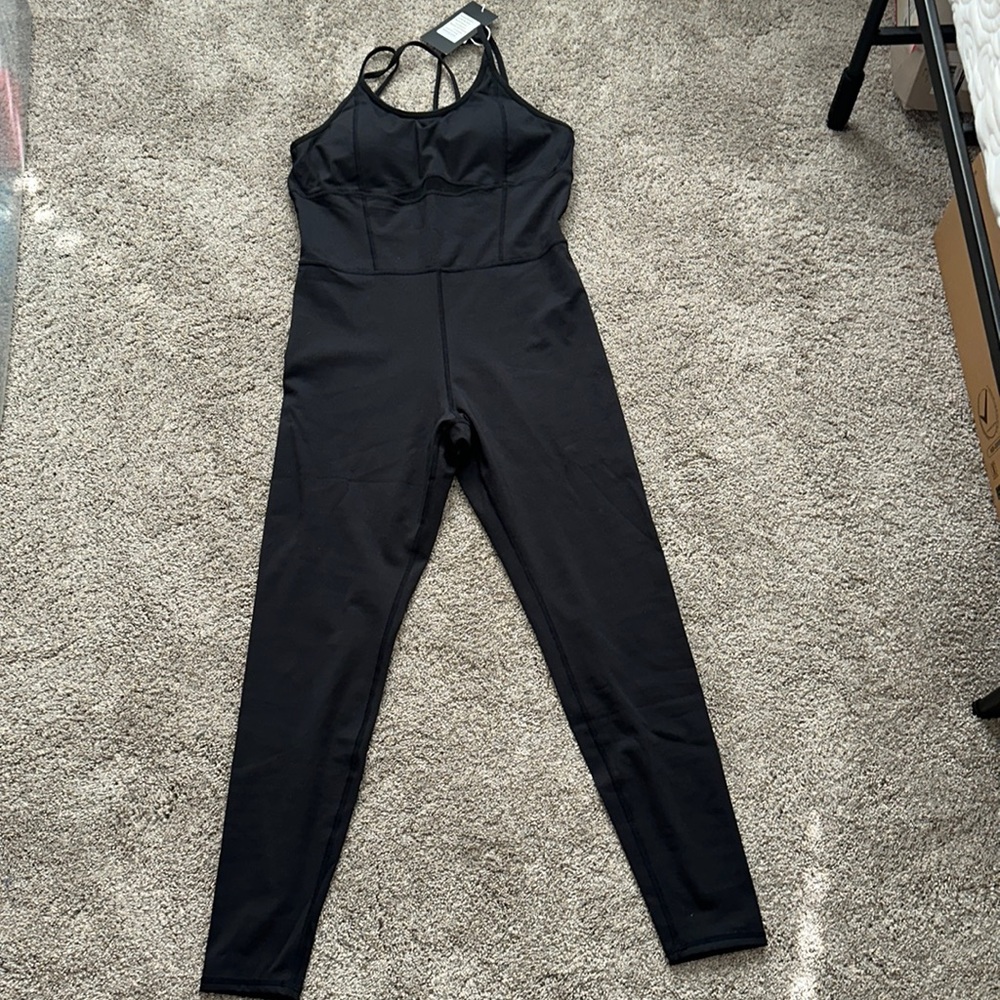 Black spandex jump suit from LOVESOFT. Mesh detail on front.